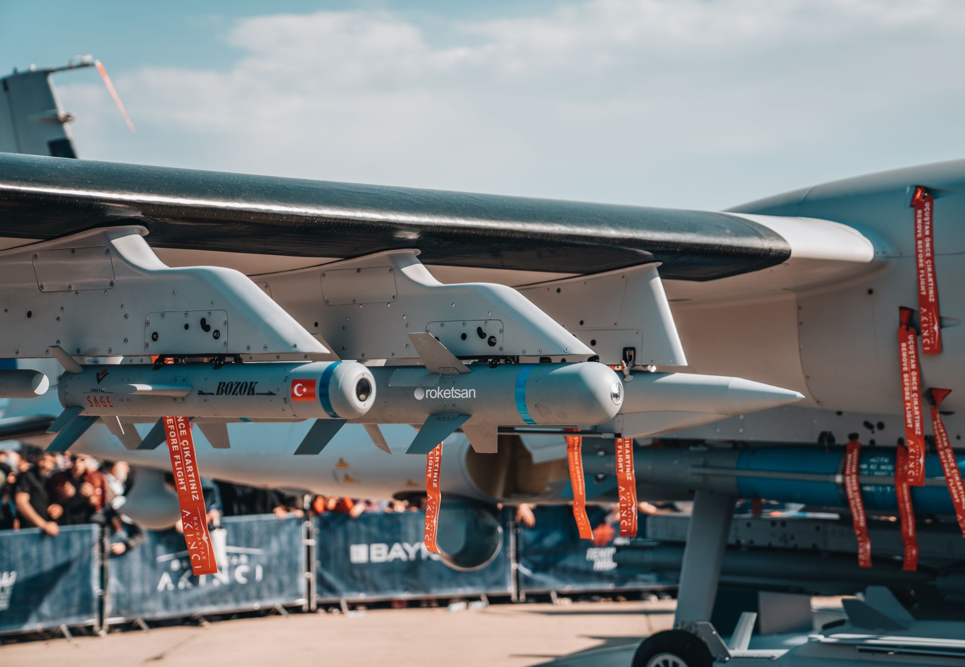 Detailed view of armaments on a Turkish military aircraft displayed at an air show.